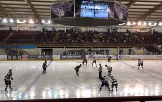 Ice Hockey game ongoing below showing 'Dizzytron' unit above the ice snowing two sides of screens.