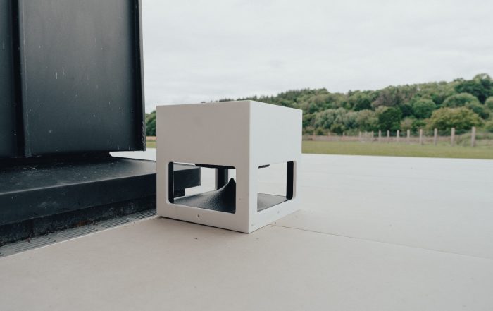 Garvan outdoor Loto 360 Case speaker placed in a patio area outside a house.